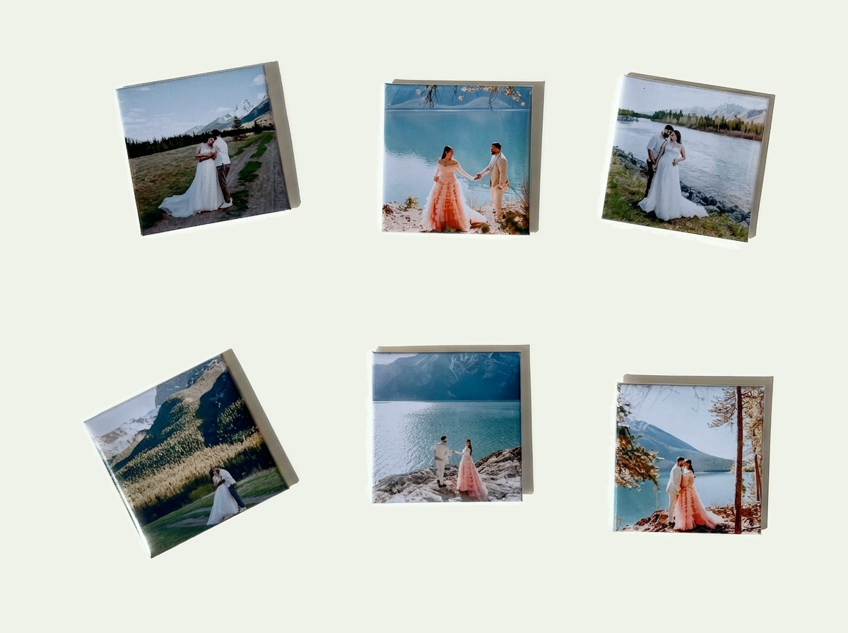 Six custom photo magnets, each printed with a wedding photograph, arranged on ivory paper